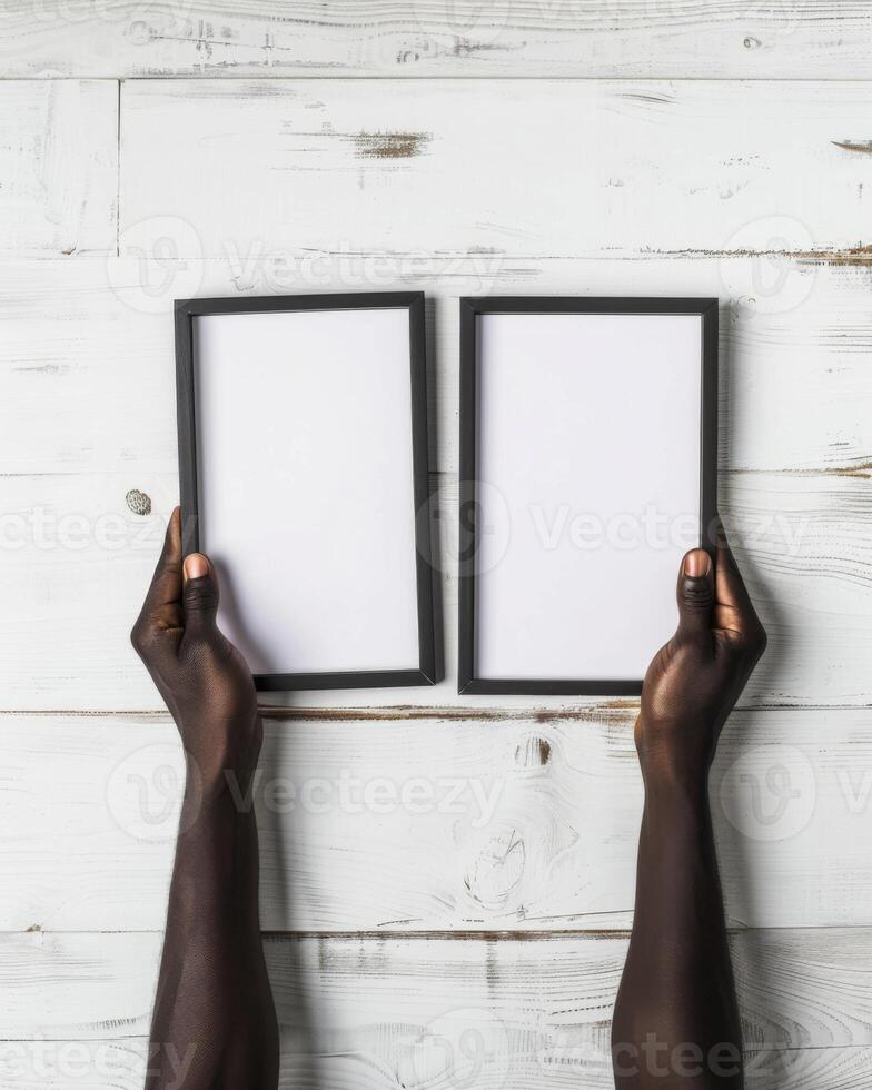 Hands Placing Blank Photo Frames on Wall for Mockup