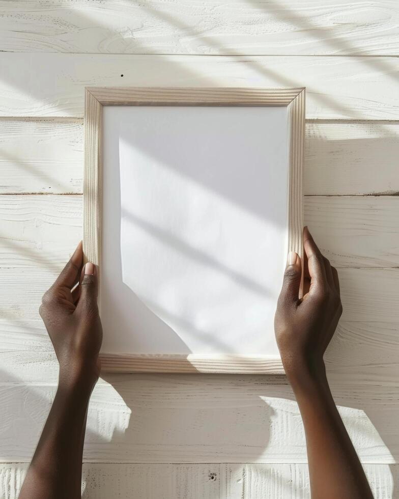 Hands Placing Blank Photo Frames on Wall for Mockup