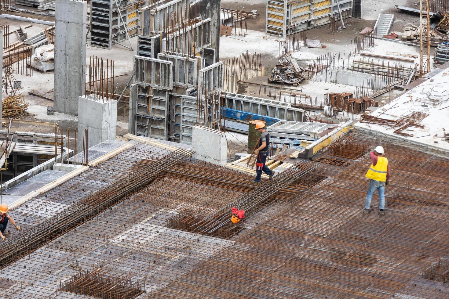 Managers, engineers discuss the further process of work on the construction site photo