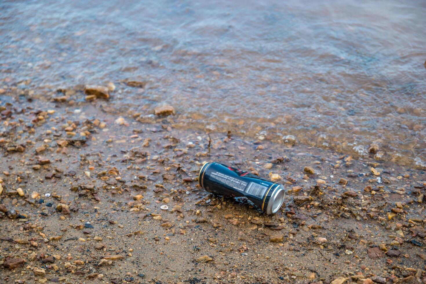 Can left on the beach at the lake photo