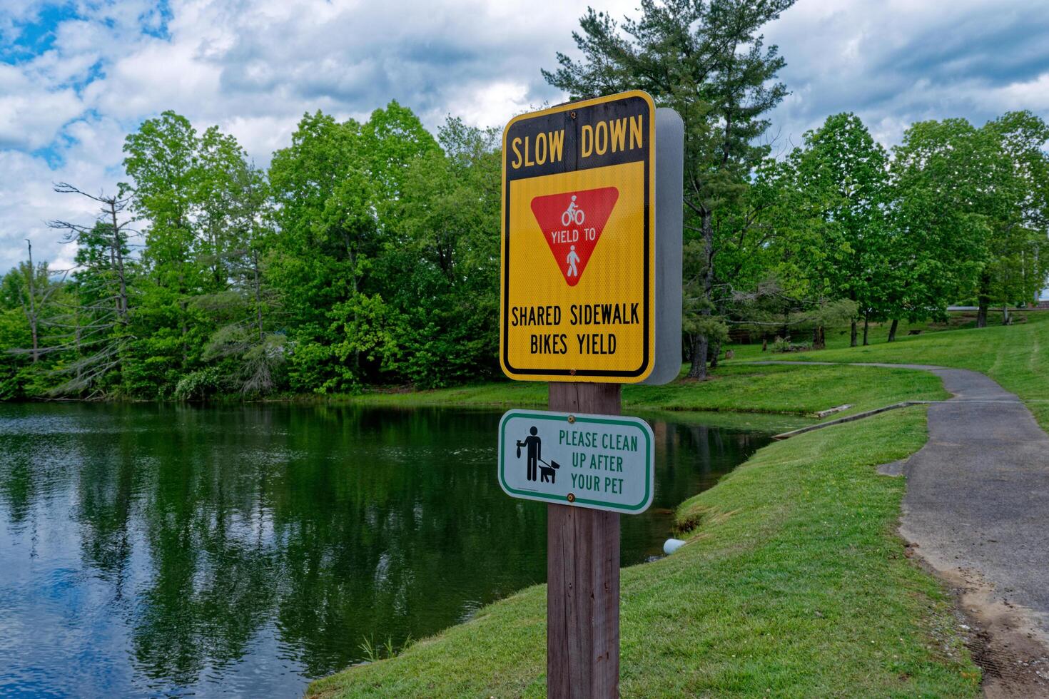 Slow down signage on a trail photo