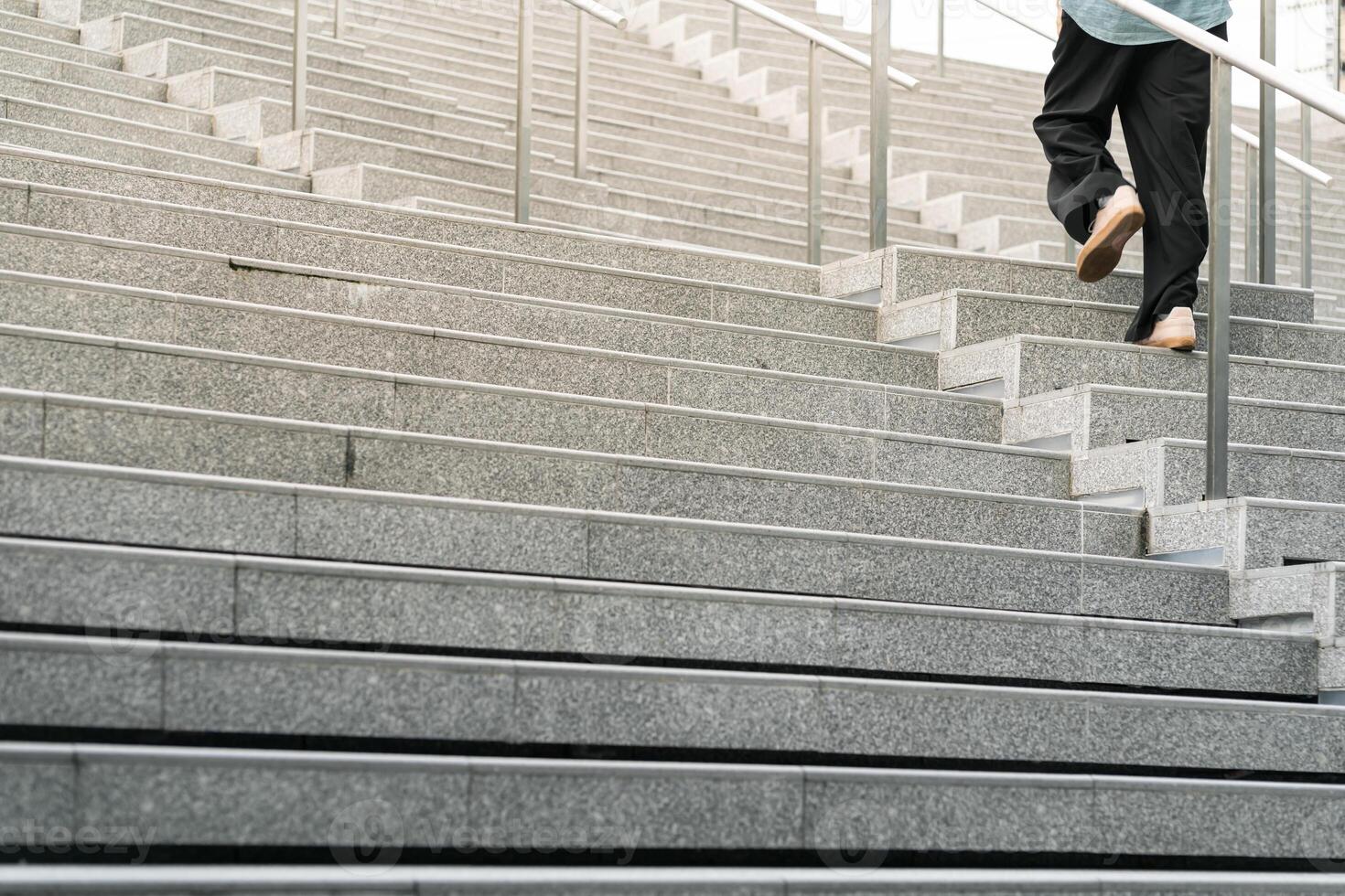 Abstract stairs in black and white, abstract steps, stairs in the city. A modern staircase with wide, smooth concrete steps and sleek stainless steel handrails. photo