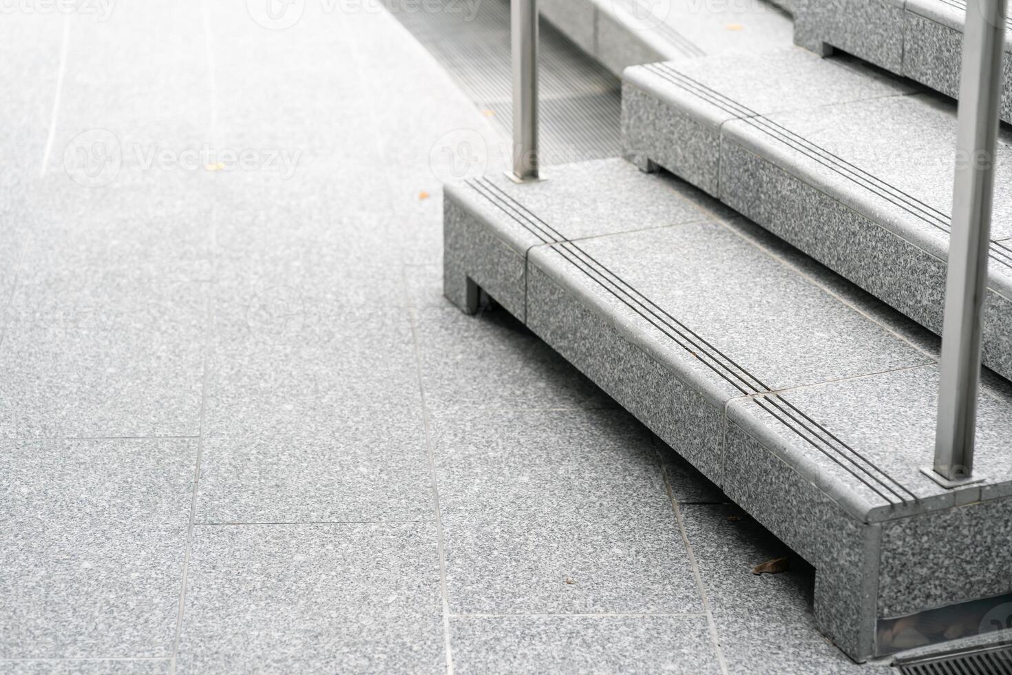Abstract stairs in black and white, abstract steps, stairs in the city. A modern staircase with wide, smooth concrete steps and sleek stainless steel handrails. photo