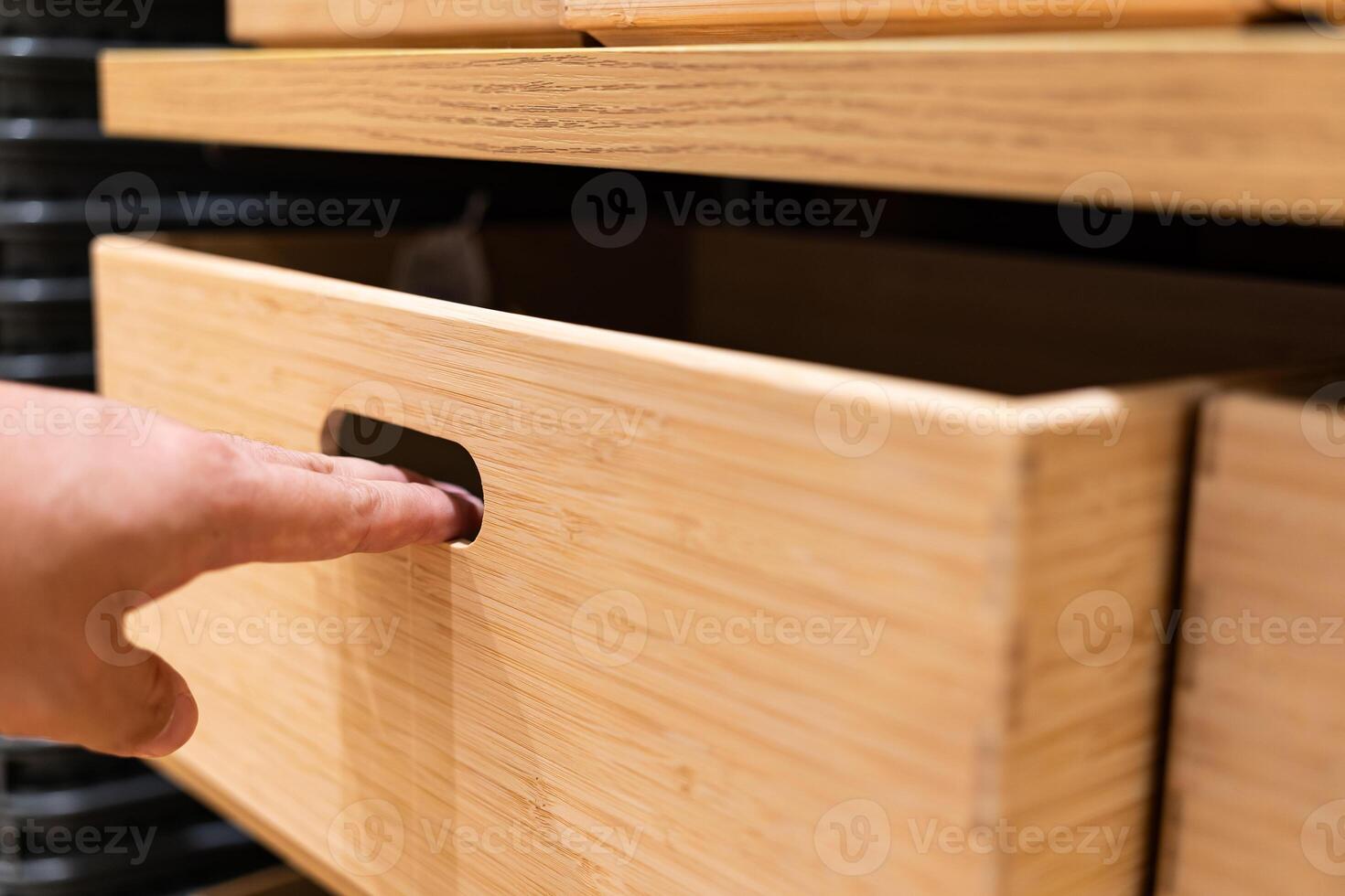 Hand opening the wooden drawer. Use hand pull open drawer wooden in cabinet. photo