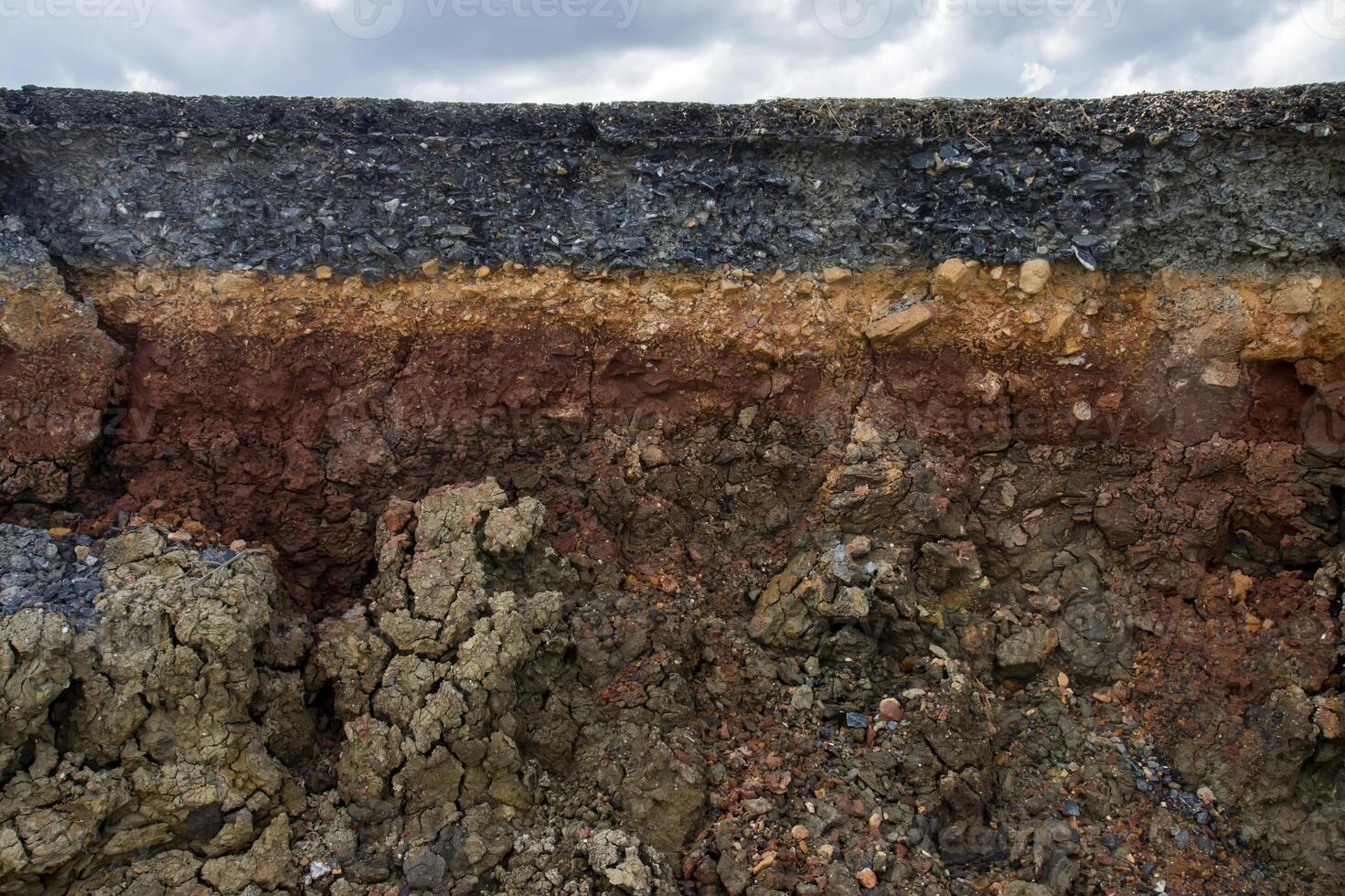 The curb erosion from storms. To indicate the layers of soil and rock. photo