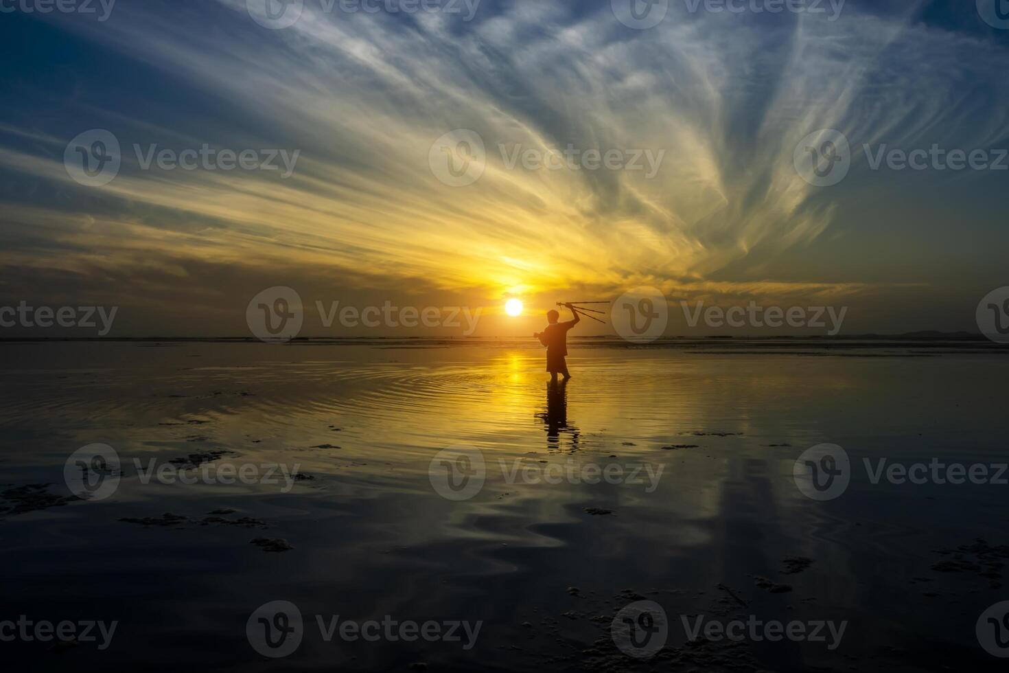 Silhuette men with sunrise sky at the lake. photo