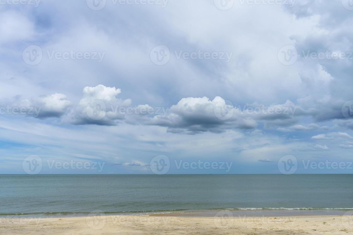 Nobody on the beach with blue sky and clouds in rain season. photo