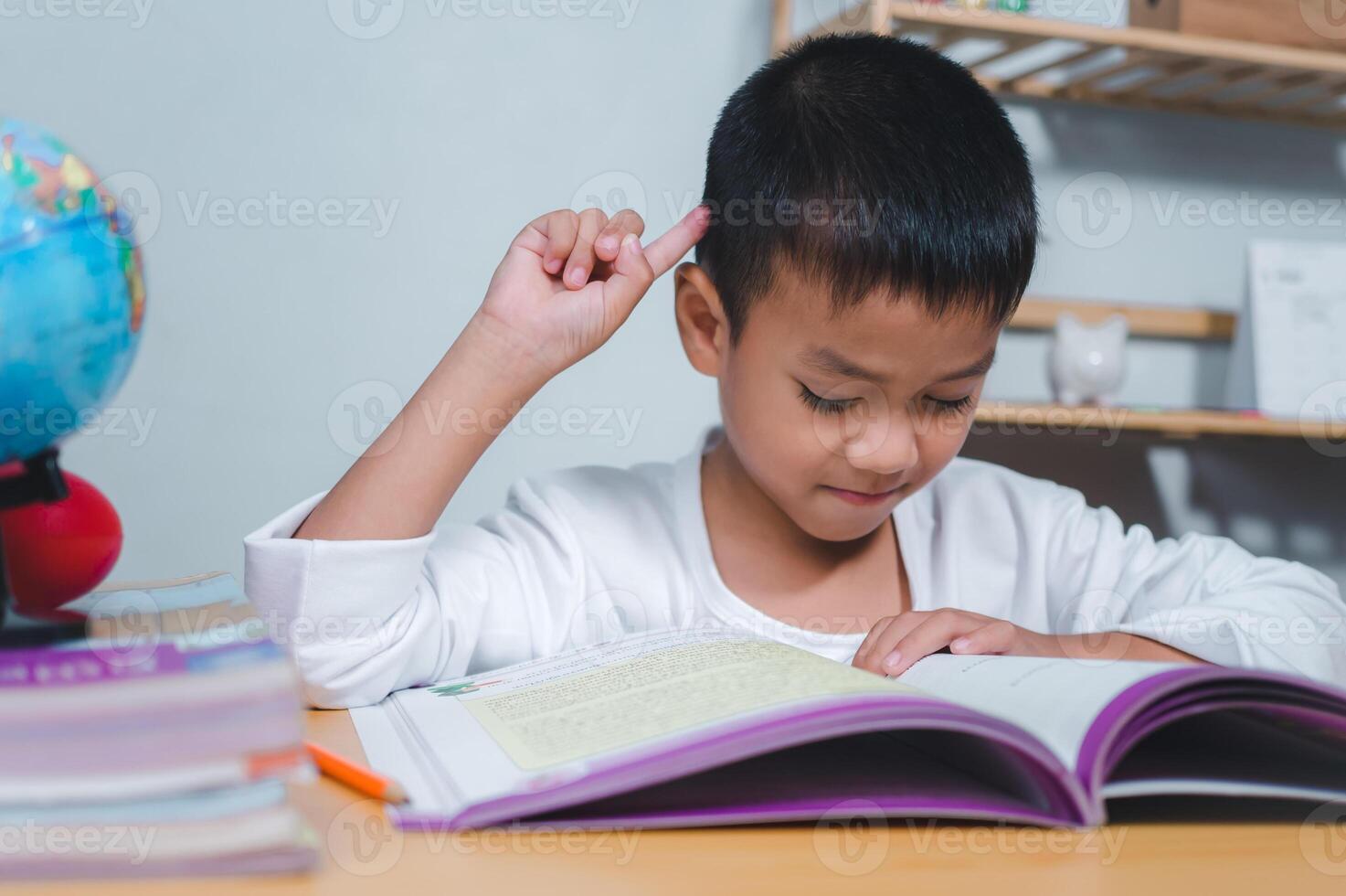 Education concept, Sad tired frustrated boy sitting at the table with many books, Bored and tired boy doing homework on desk in his room, Learning difficulties. photo