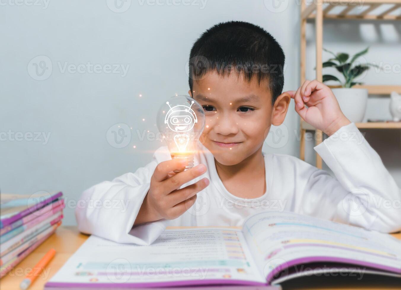 Boy holding a bright light bulb to represent new creativity, Education concept, Smart kid against green blackboard, Idea and creativity concept, Copy space for your text. photo