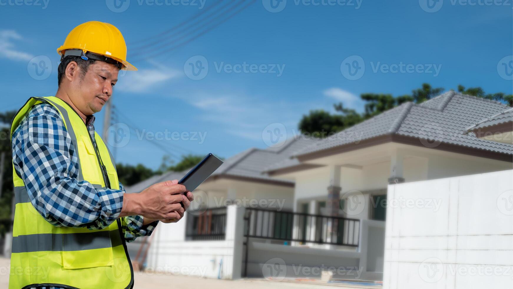 Engineer architect with protective helmet working at house building on construction site background, Housing projects, Residential construction projects. photo