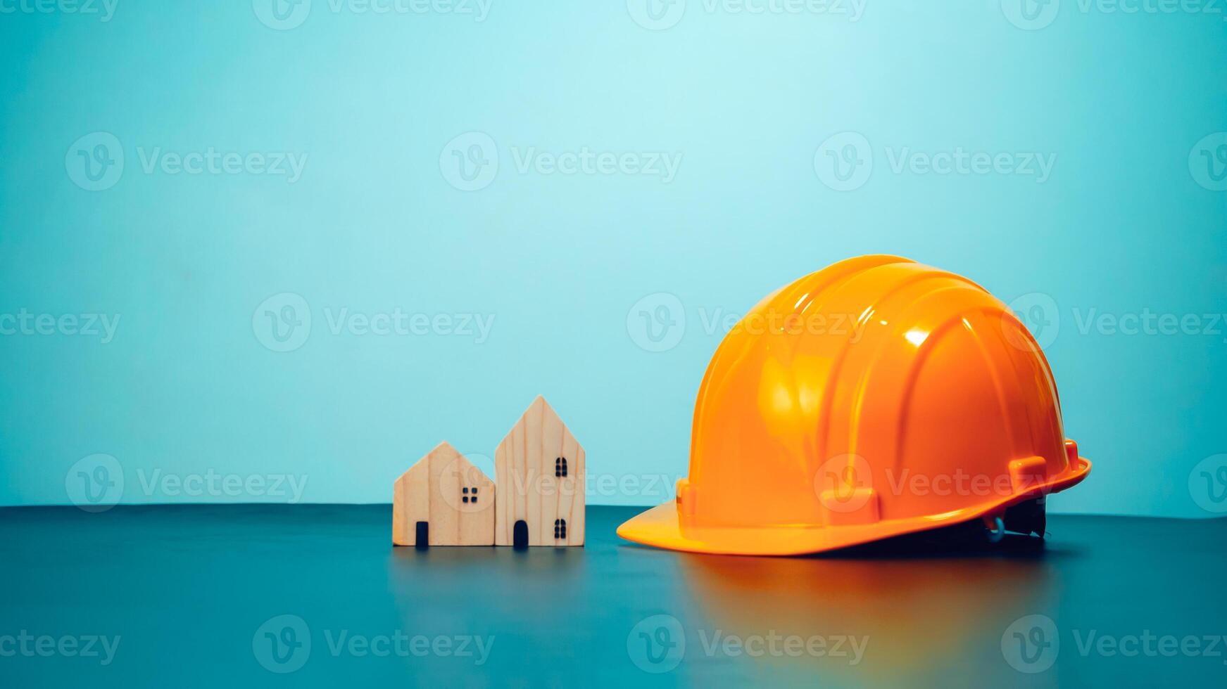 Hard hat for construction site workers and for engineers or workers, Standard safety helmet head protection, Wooden house model with hard hat with copy space, Engineering construction concept. photo