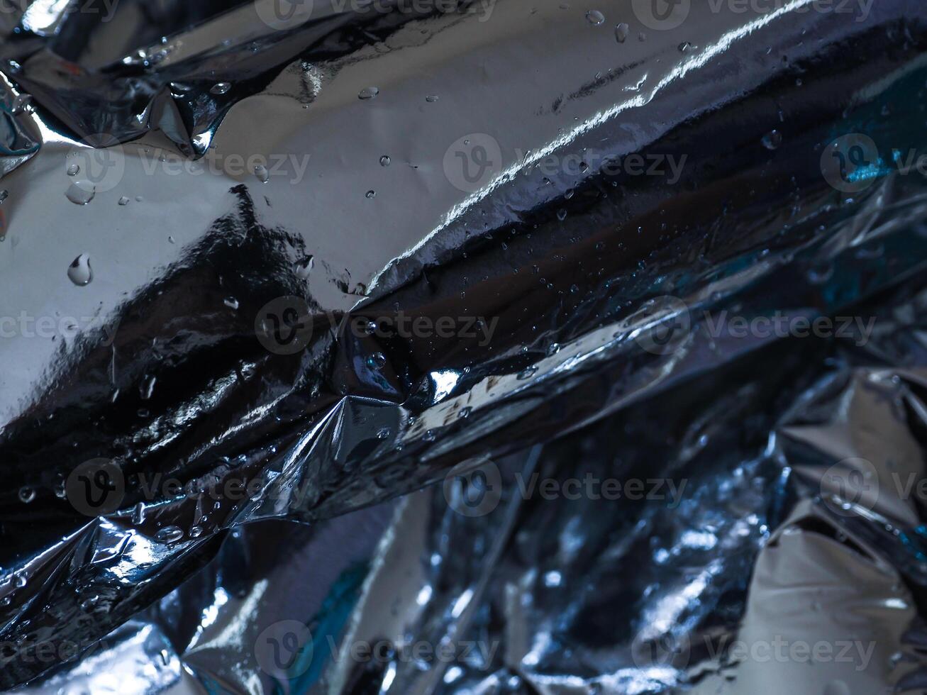 Silver plastic texture in the dark for a mysterious abstract background. photo