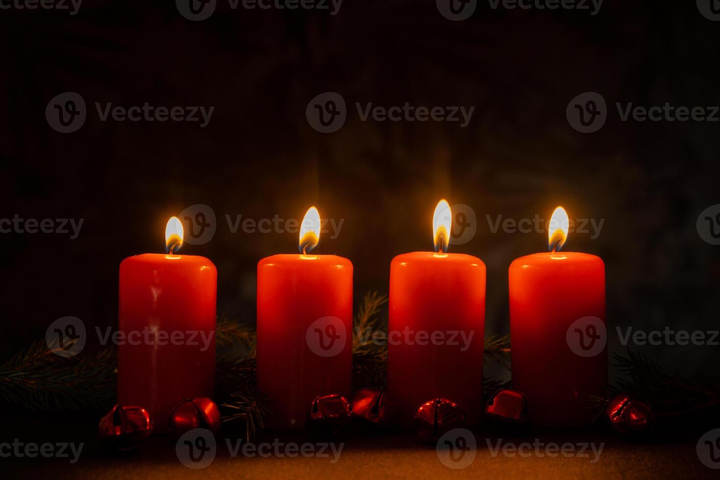New year and Christmas preparation. Four red advent candles burning in dark room. Handmade eco-friendly decor. Sustainable Christmas decoration. Copy space photo