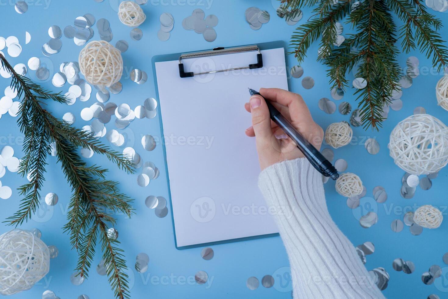 Woman writing letter to SANTA or promises and aims. Empty notebook Preparation for new year. Visualizing wish list for 2025. Dreams plan action resolutions for coming year. Inspirational self improvement concept photo