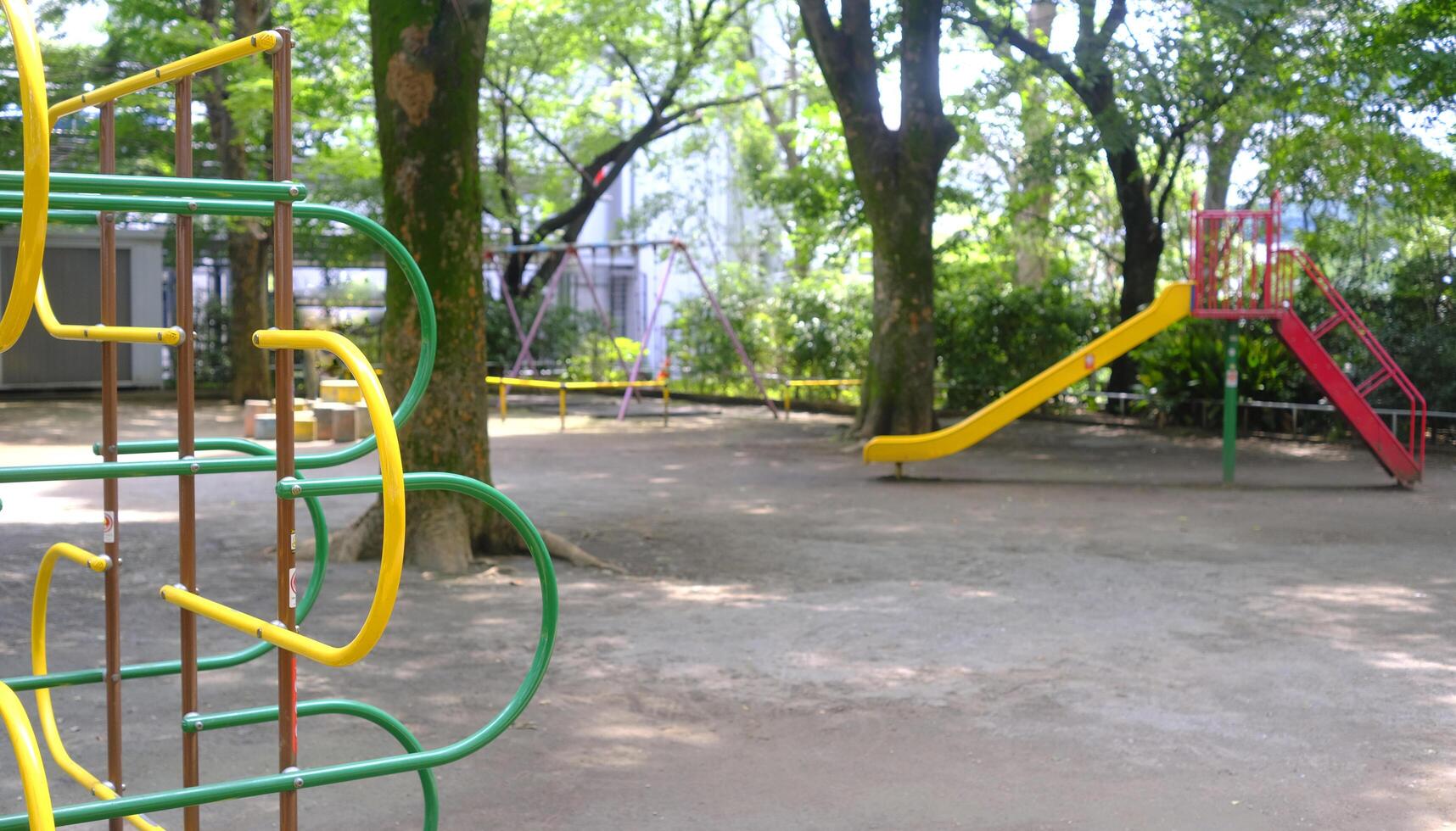 Yellow joyful slide and climbing frame for child and kids in Japan playground photo