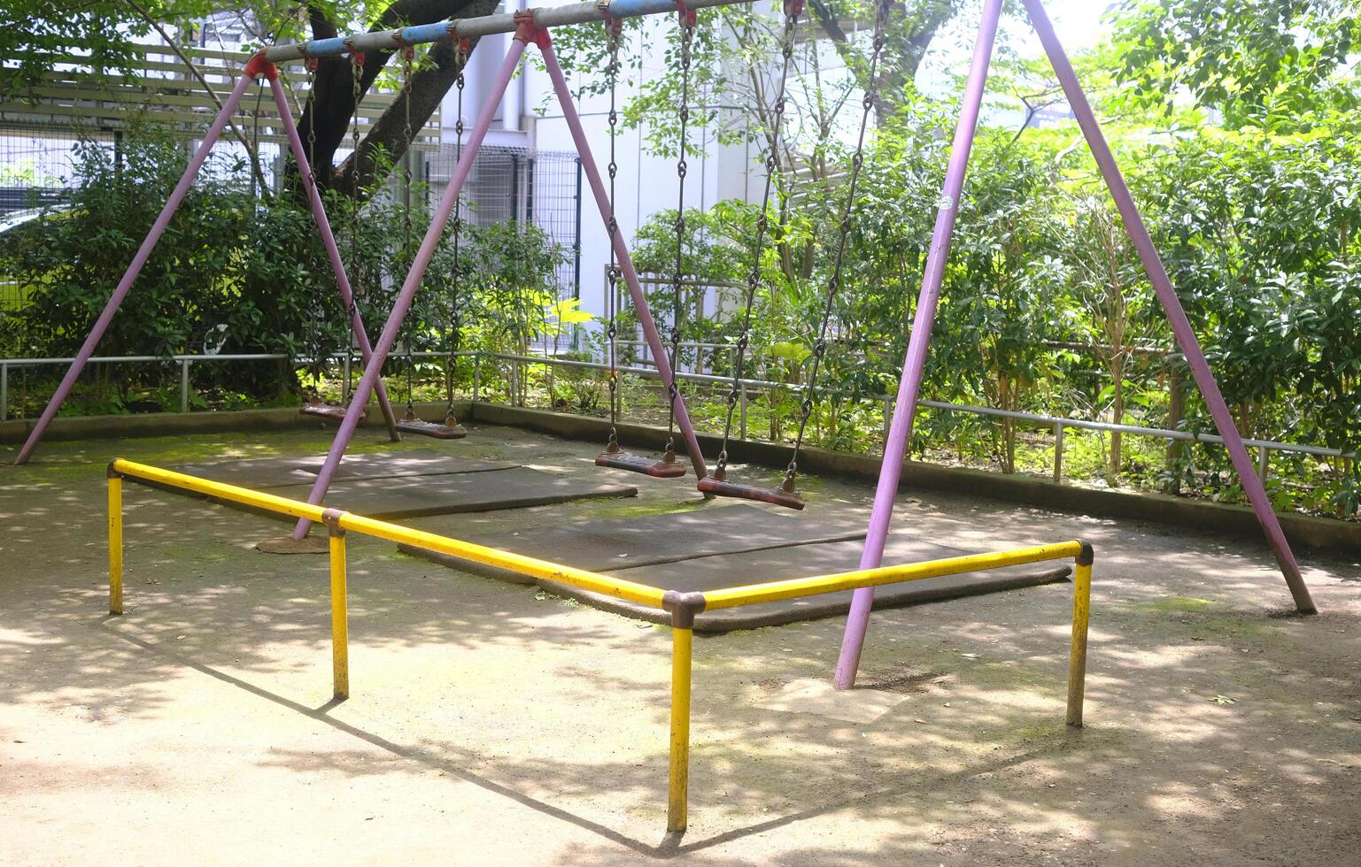 Pink joyful swing for child and kids in Japan playground photo