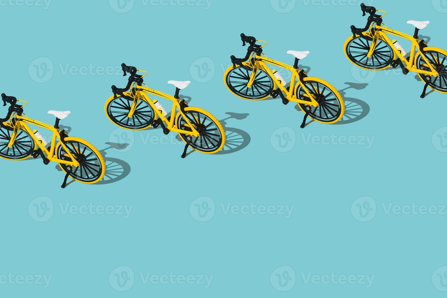 Trendy sport pattern made of yellow bicycle on pastel blue background with copy space. Minimal bicycling concept. Creative sport bike pattern backdrop idea. photo
