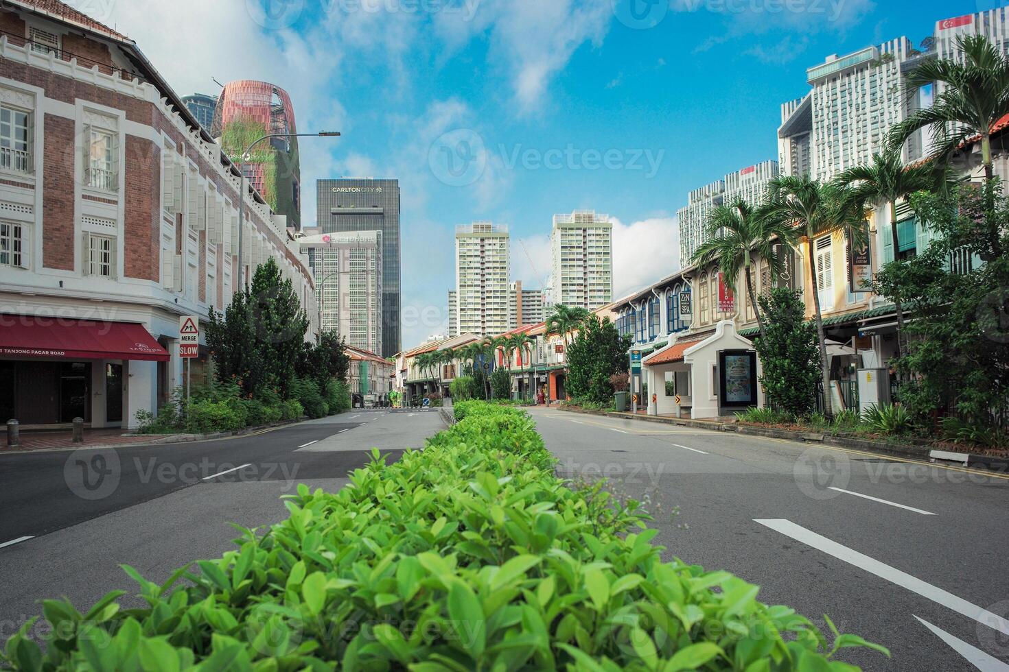 Singapore, Chinatown,August 20, 2023-Perspective of empty road along with rows of vintage house and modern building background photo