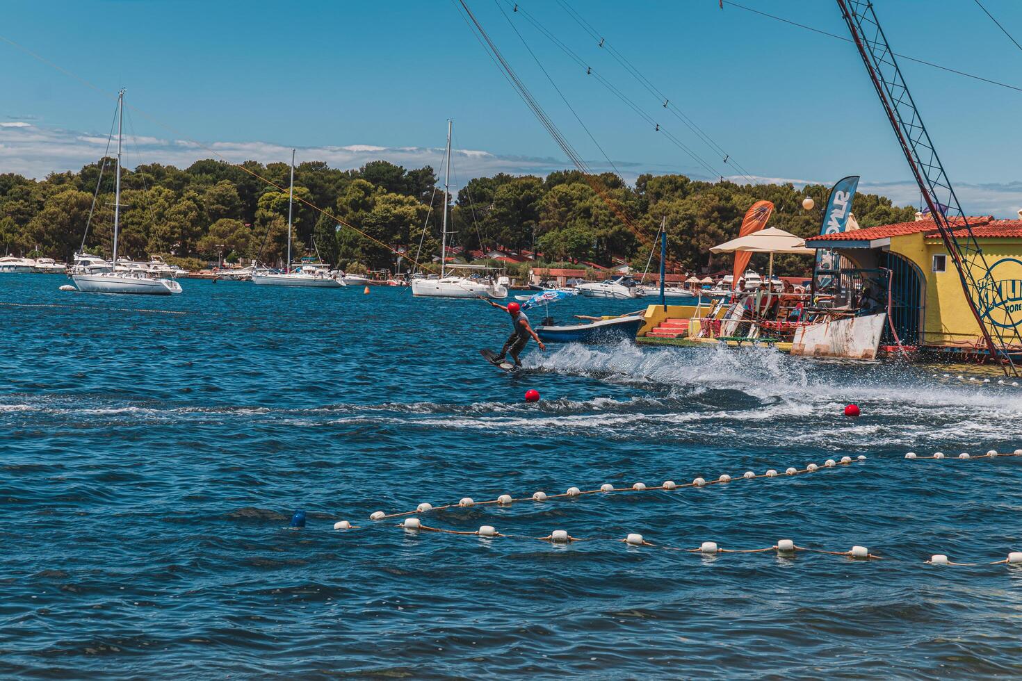 A man wakeboarding on the sea a sunny summer day Porec Croatia 02.07.2024 photo