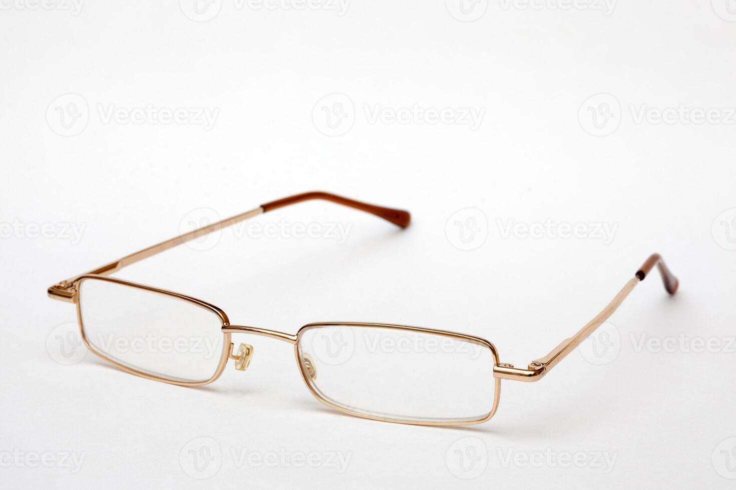 Glasses in thin metal frame on white background. Vision correction. photo