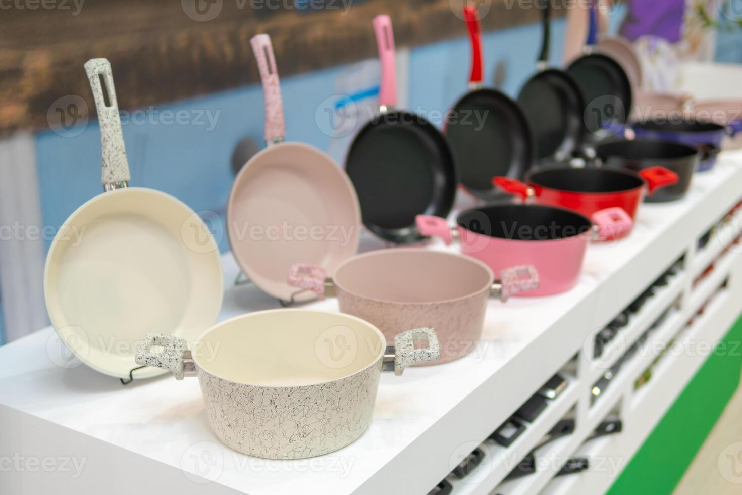 Frying pans and kitchen pans on the shelf in the store. photo