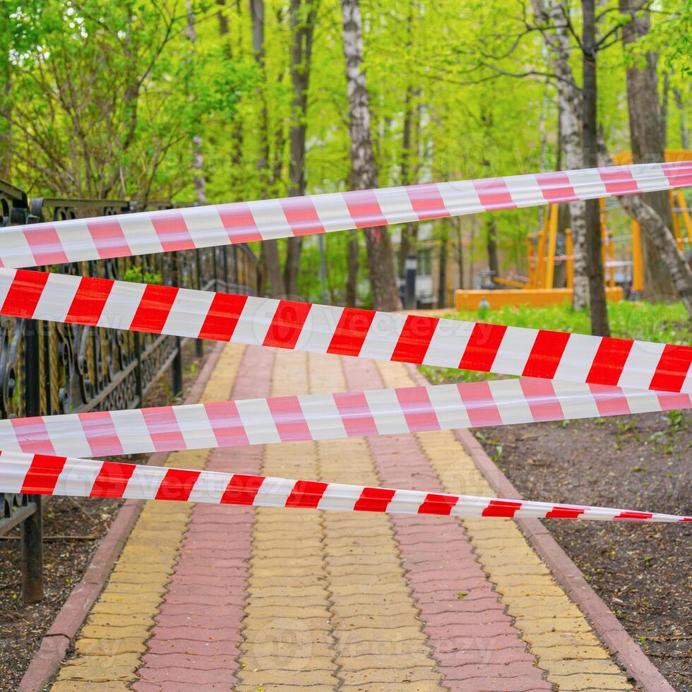 Ban on entry to park. Banning tape blocks entry. Quarantine restrictions. photo
