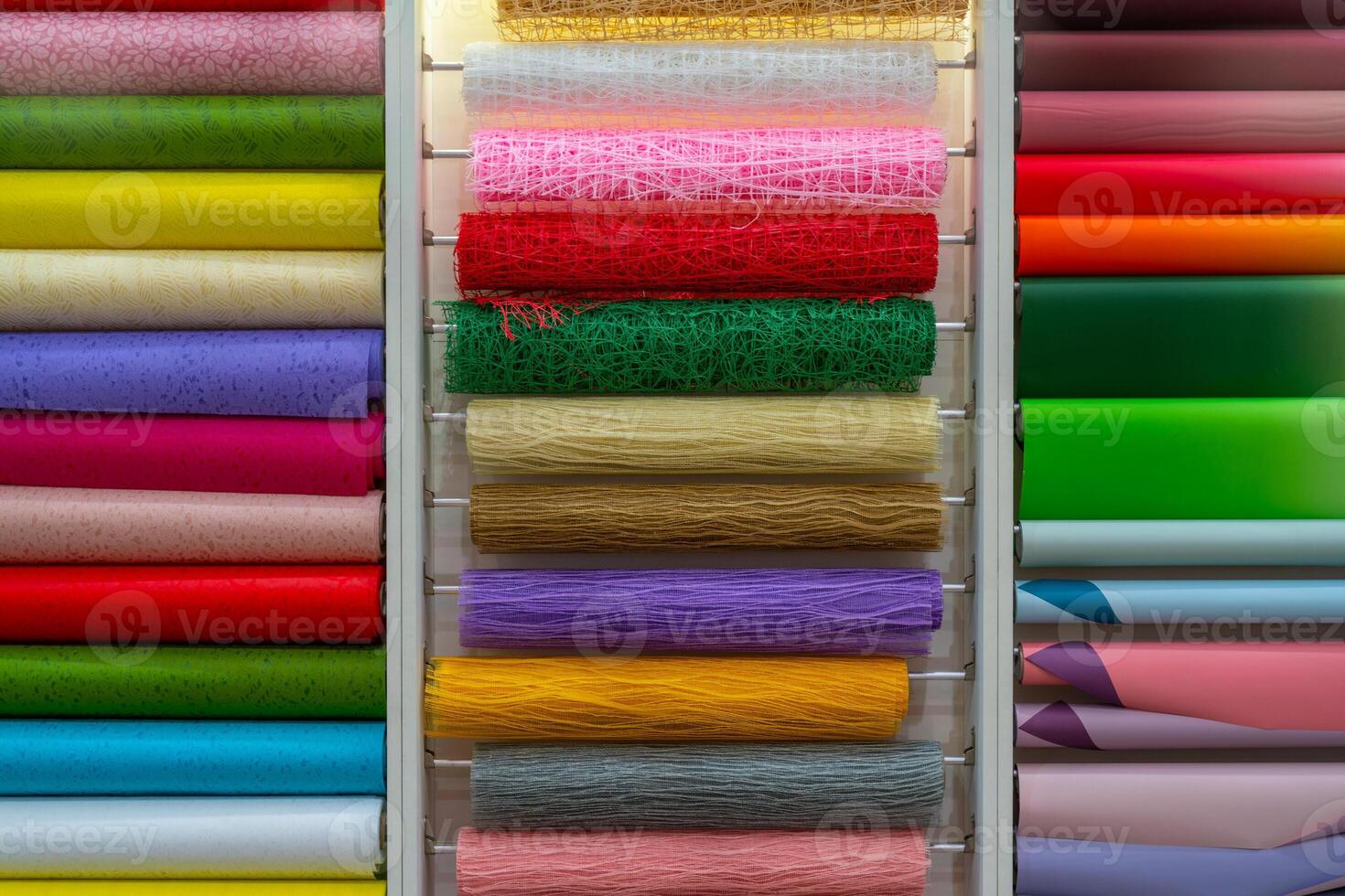 Multicolored rolls of wrapping paper on the showcase. Abstract background. photo