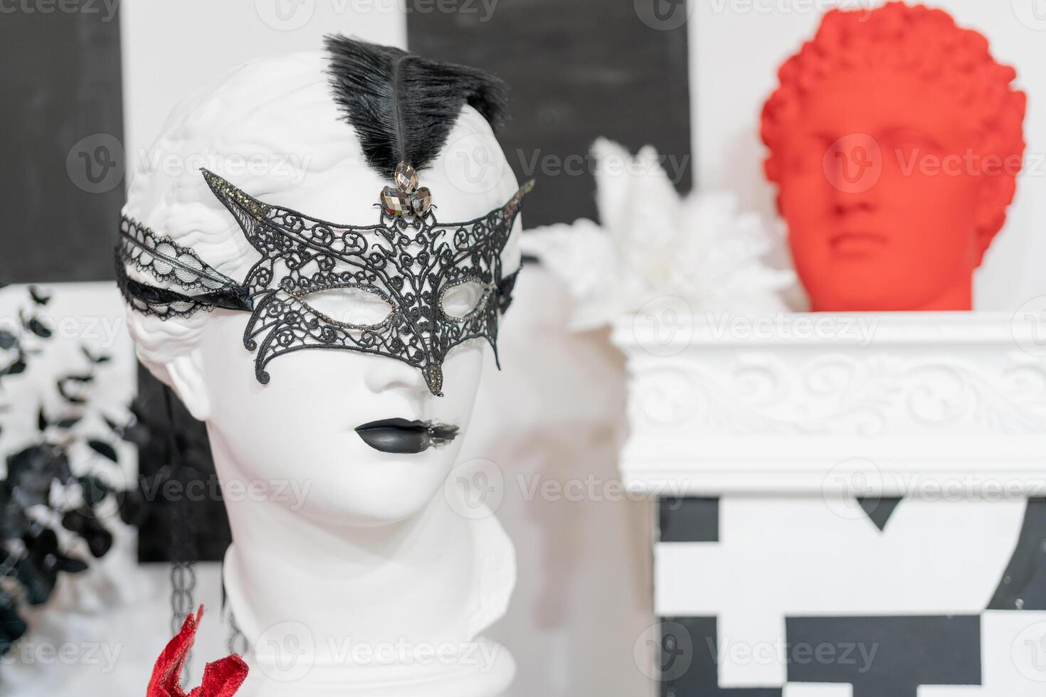 Plaster head in a carnival mask. Decorative decorations in a shop window. photo