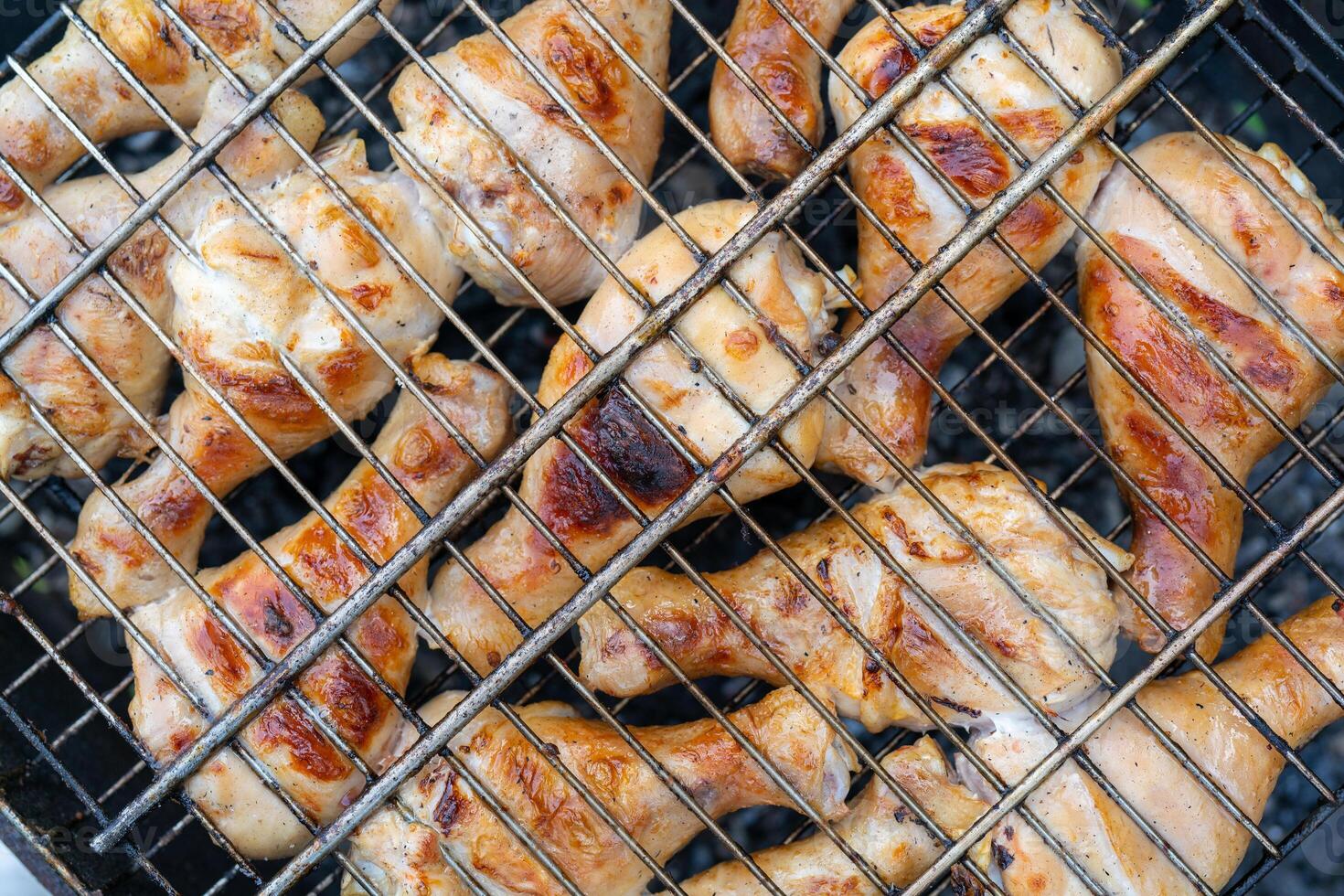 BBQ chicken legs. Cooking meat outdoors. Cooking process. photo