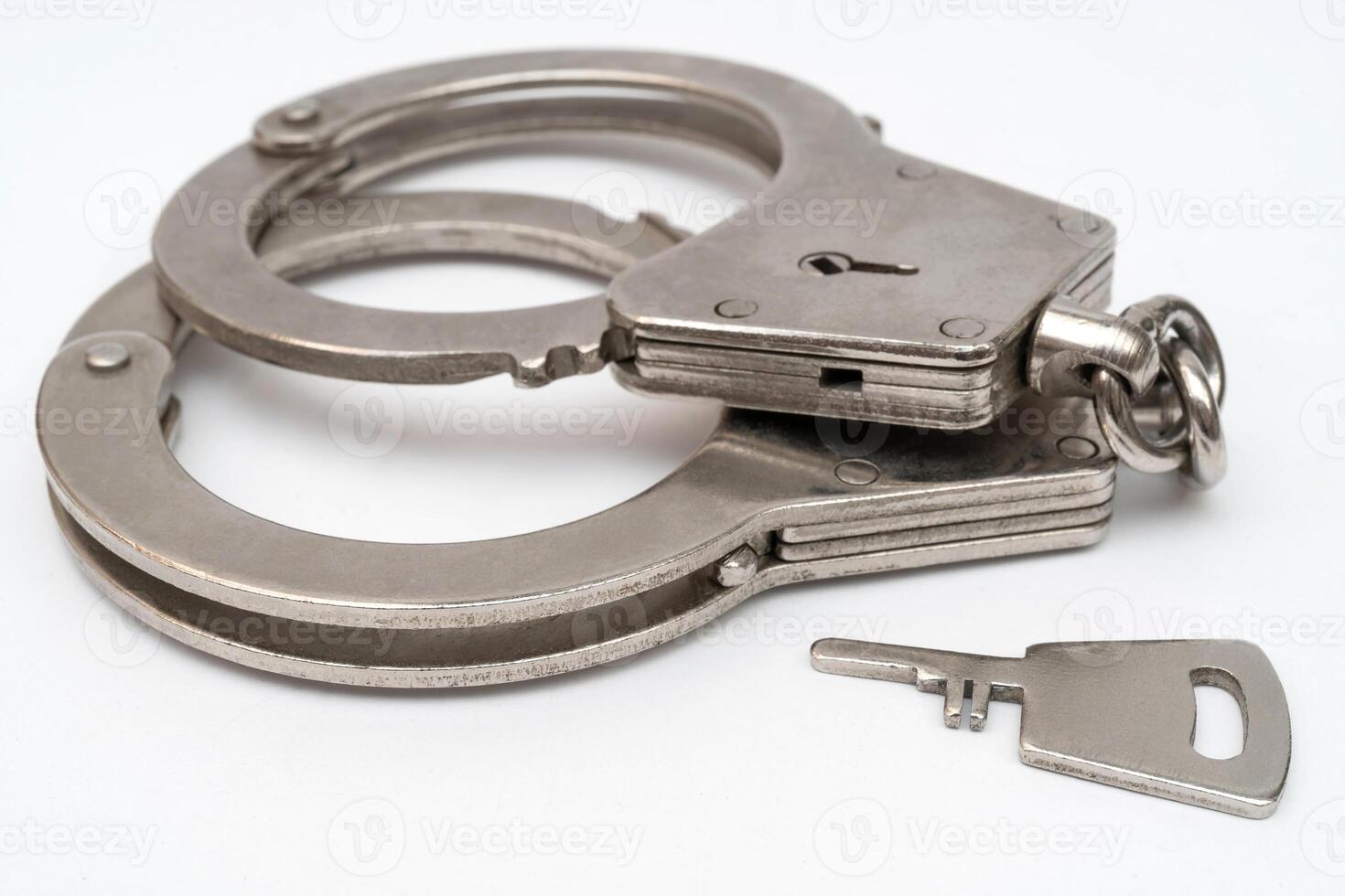 Metal handcuffs. Detention of criminals breaking law. Restriction of freedom. photo