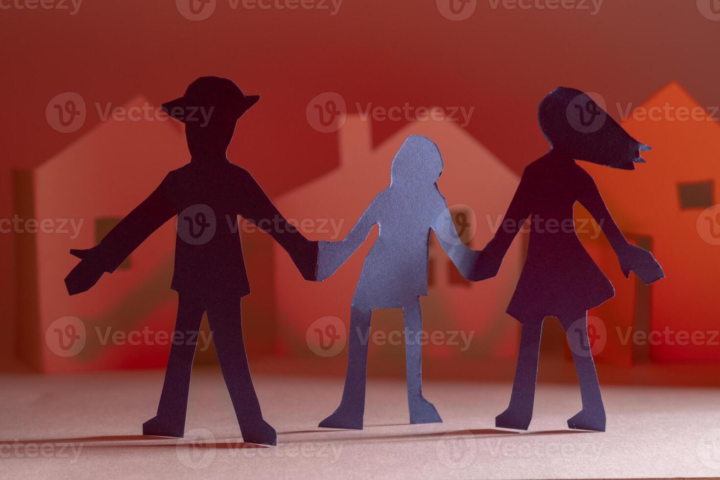 Cutting out of paper people on the background of houses. photo