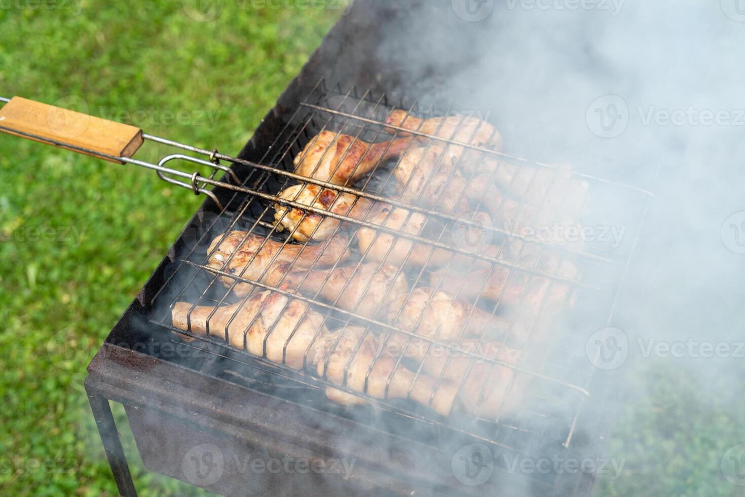 BBQ chicken legs. Cooking meat outdoors. Cooking process. photo