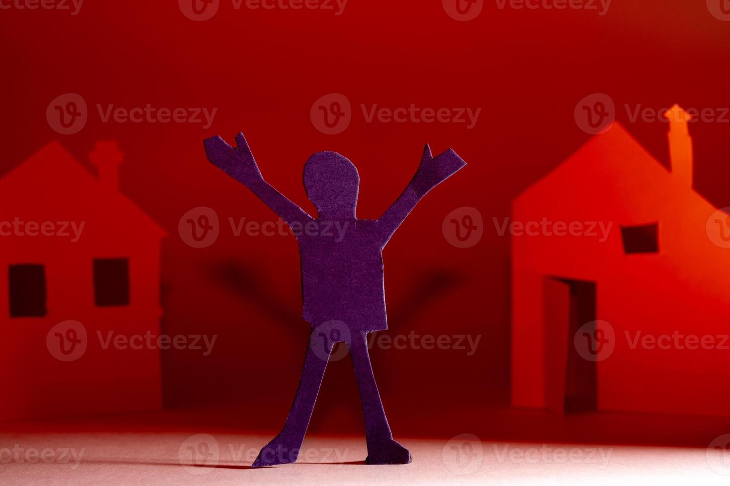 Cut from a paper person on the background of houses. photo