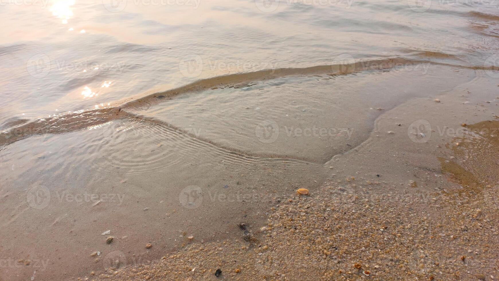 Close up soft wave lapped the sandy beach. natural abstract background and texture photo