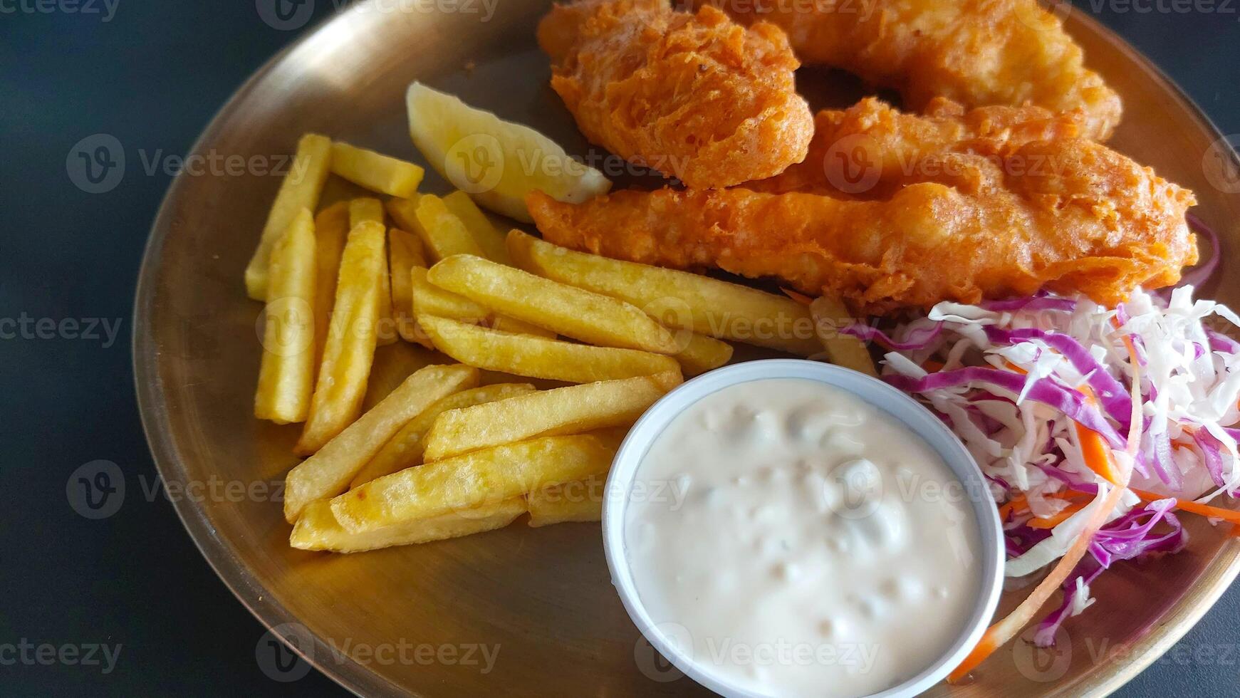 Chicken Fried schnitzel with fries on golden plate with sauce photo