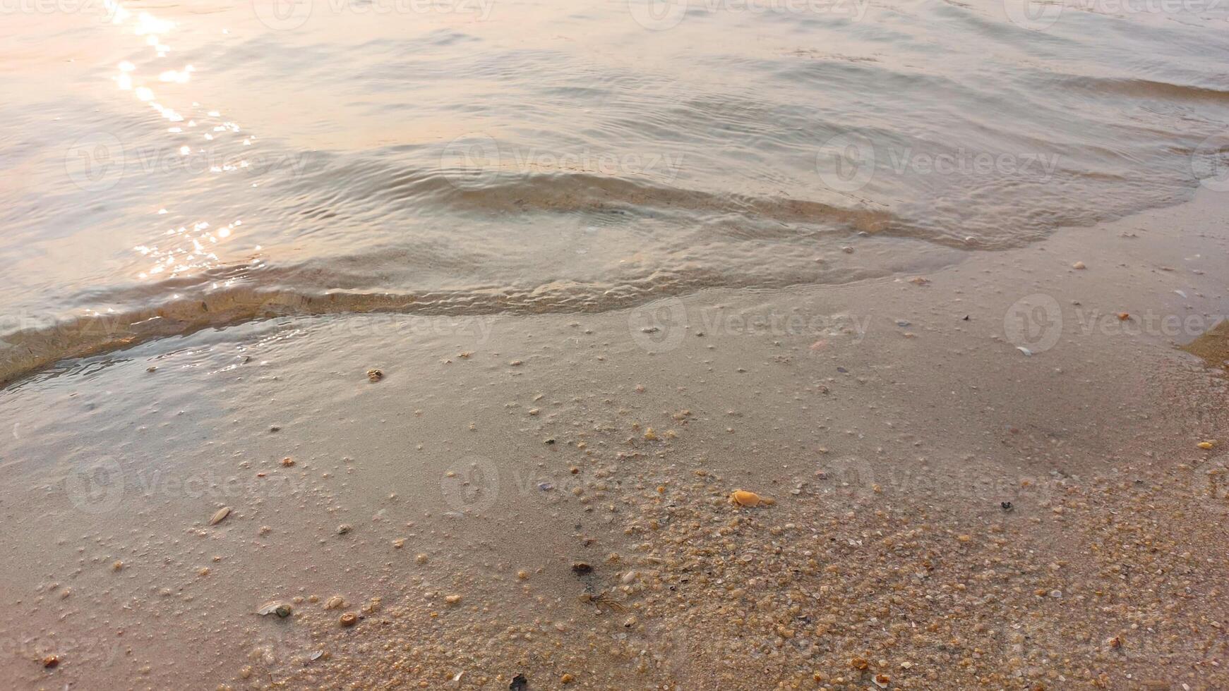 Close up soft wave lapped the sandy beach. natural abstract background and texture photo