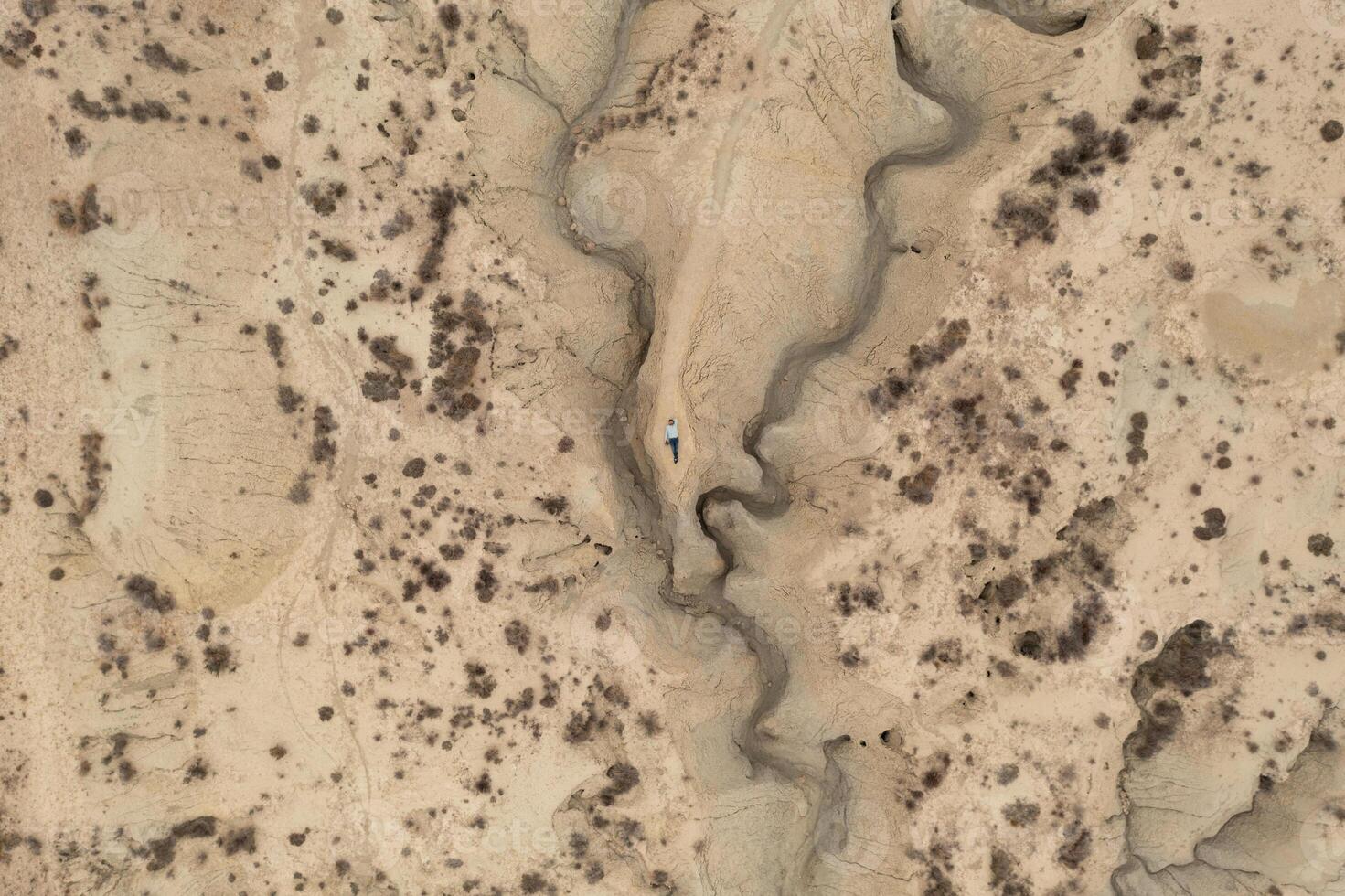 Aerial view of a man lying on the ground in the Abanilla desert or Mahoya desert in Murcia. photo
