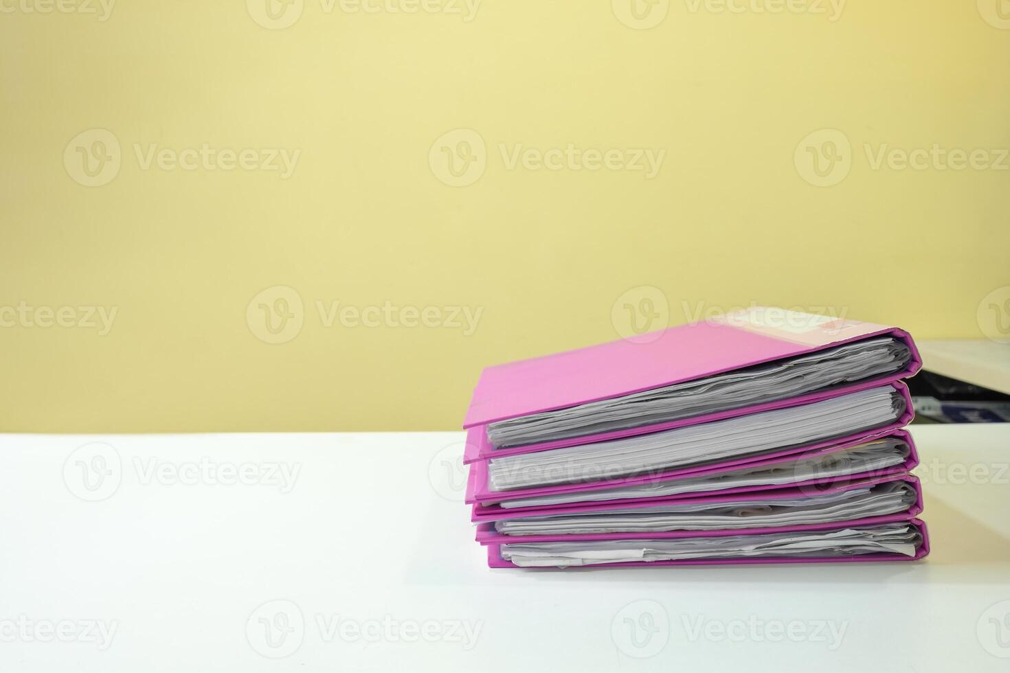 Stack of account file documents on white desk photo