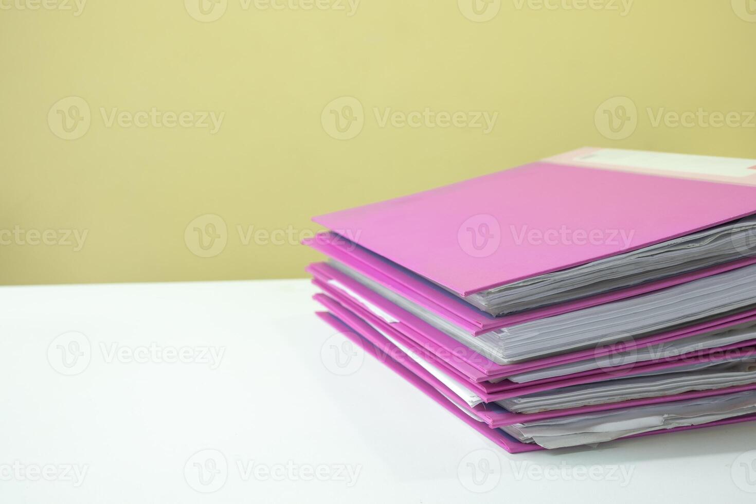 Stack of account file documents on white desk photo