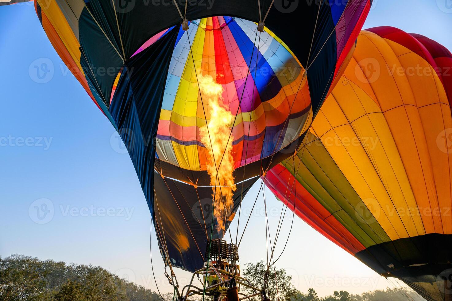 Colorful hot air balloons with burning an inflatable photo
