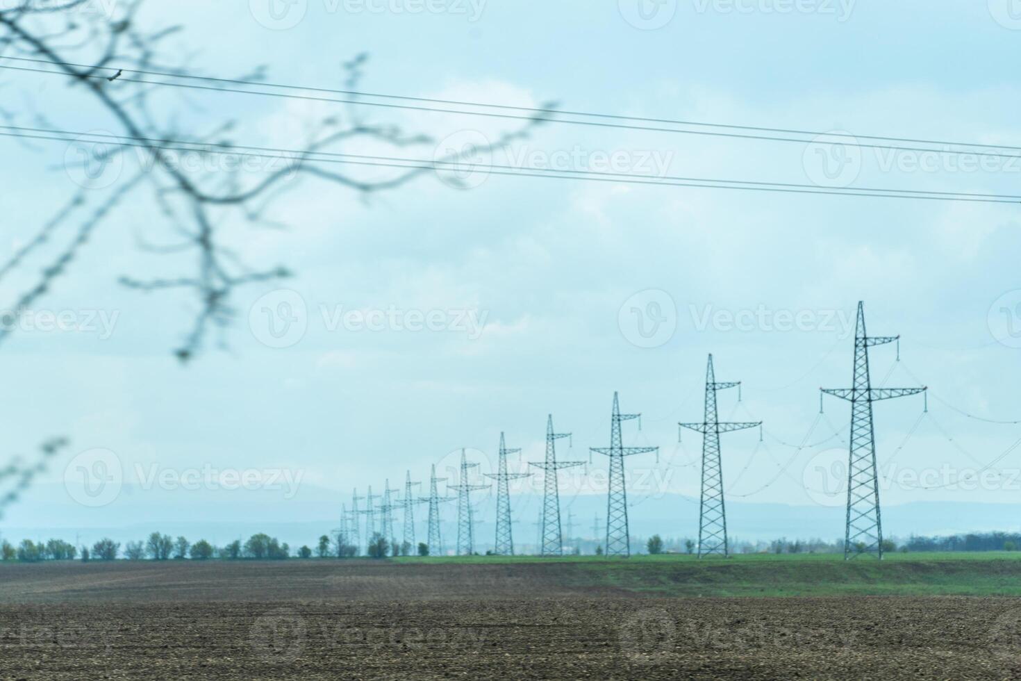 High voltage towers with sky background. Power line support with wires for electricity transmission. High voltage grid tower with wire cable at distribution station. Energy industry, energy saving photo