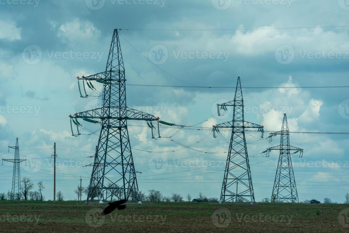 High voltage towers with sky background. Power line support with wires for electricity transmission. High voltage grid tower with wire cable at distribution station. Energy industry, energy saving photo