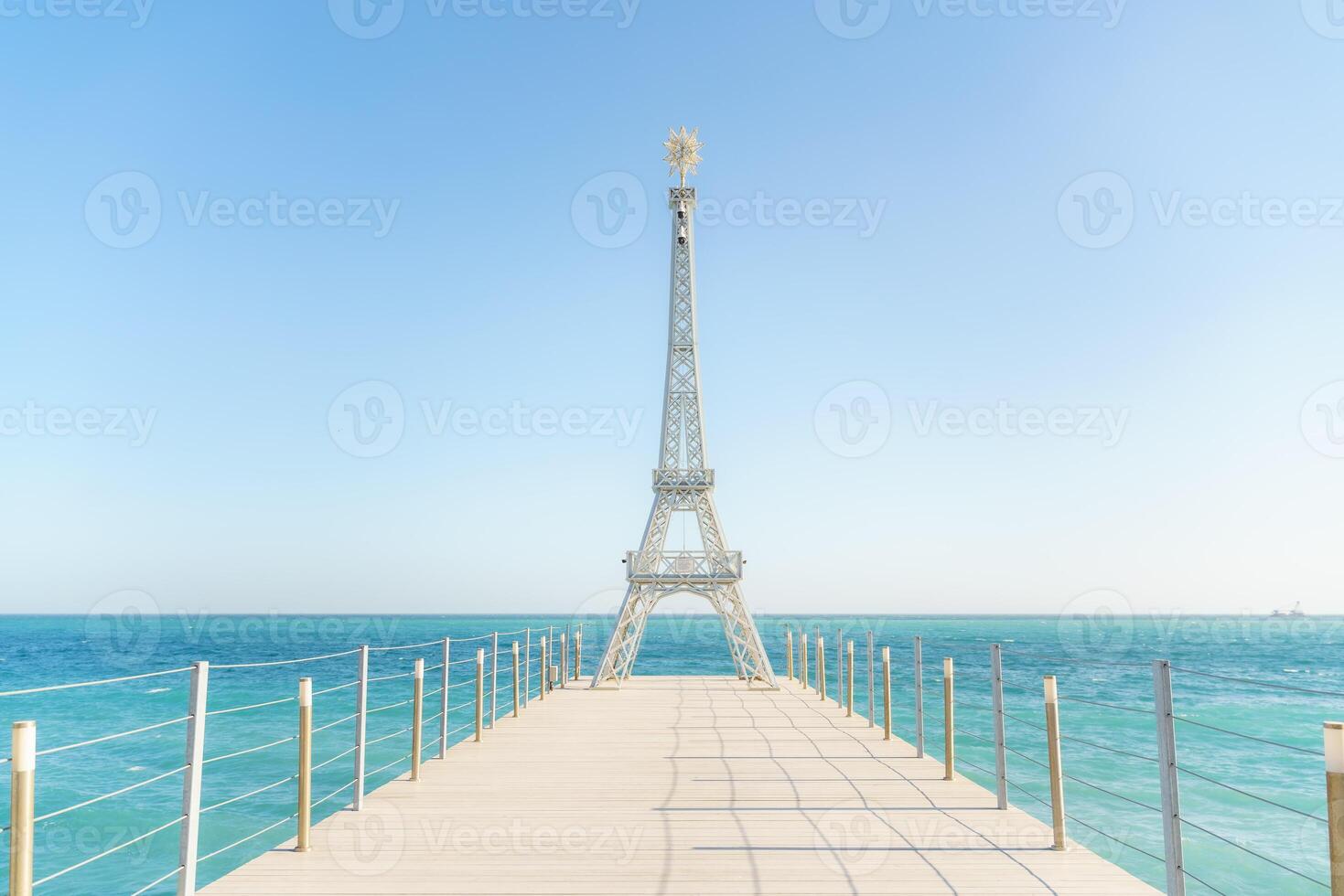 Large model of the Eiffel Tower on the beach. photo