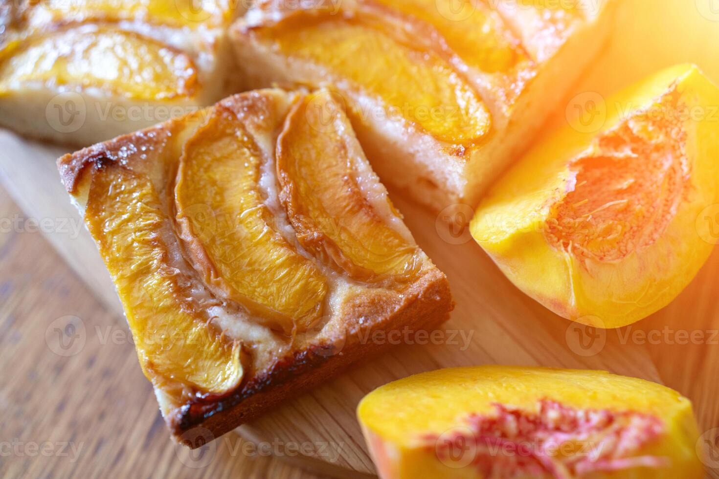 peach tart and fresh fruit closeup on wooden background horizontal view from above photo