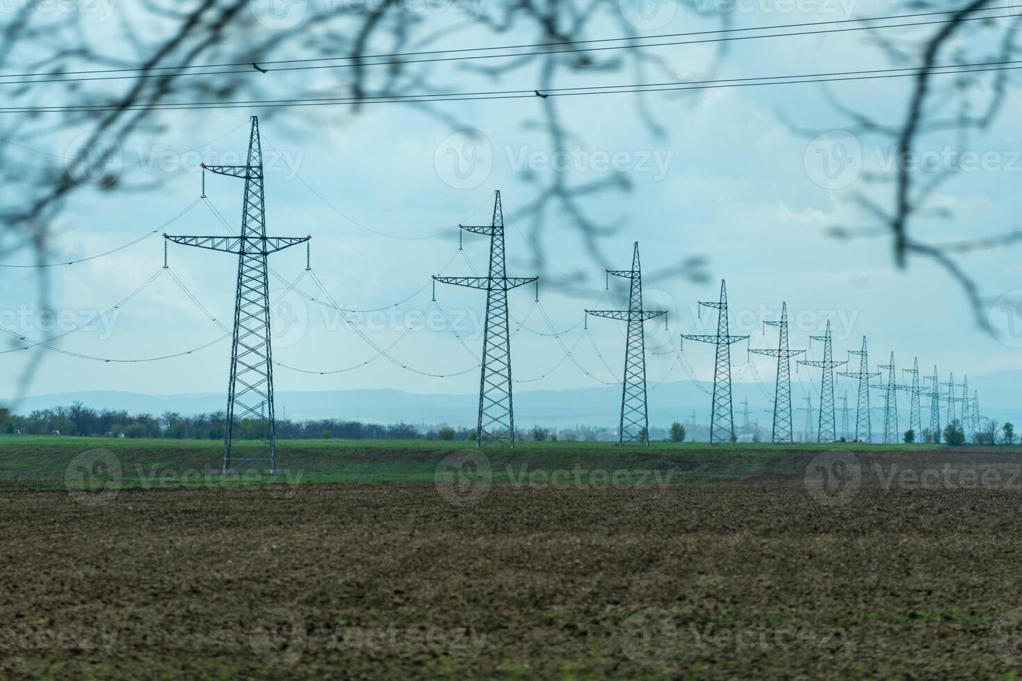 High voltage towers with sky background. Power line support with wires for electricity transmission. High voltage grid tower with wire cable at distribution station. Energy industry, energy saving photo