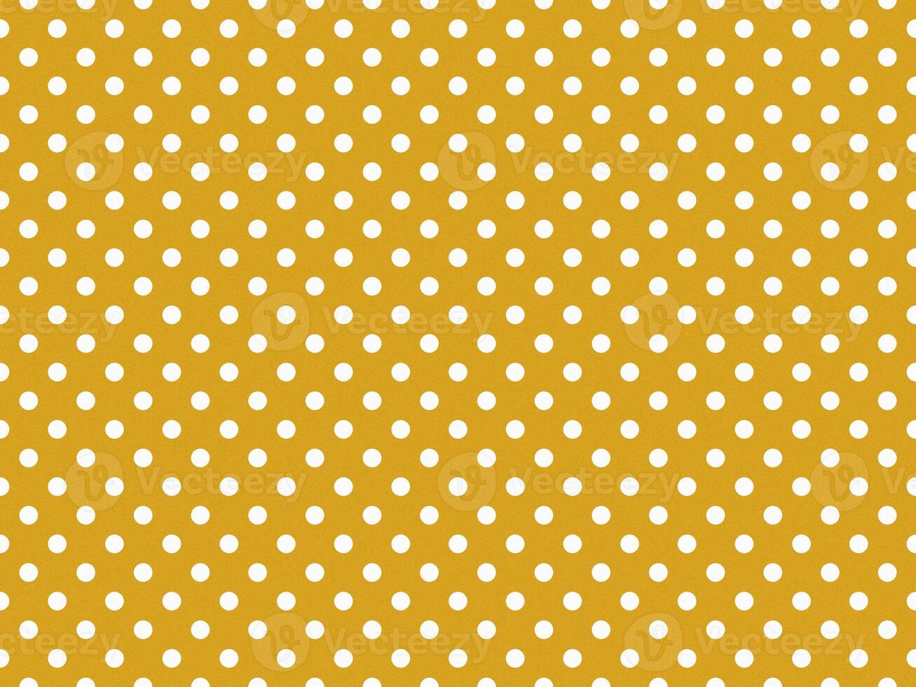 texturised white color polka dots over goldenrod brown backgroun photo