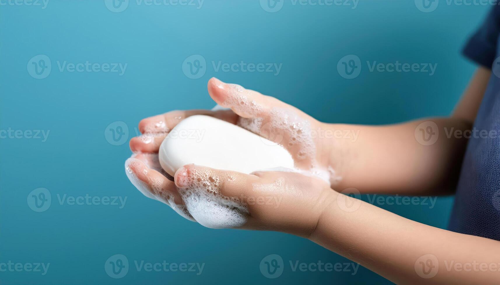 Close up Side view of young preschool aged child washing hands with soap photo