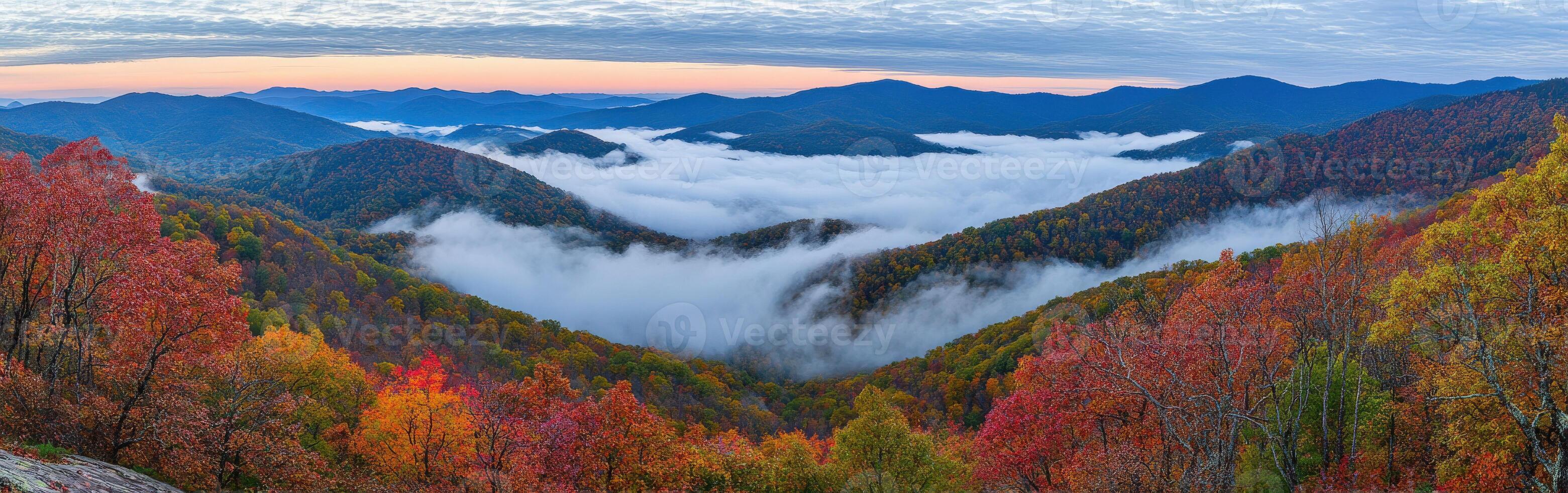 Misty autumn landscape in the mountains with colorful foliage at dawn photo
