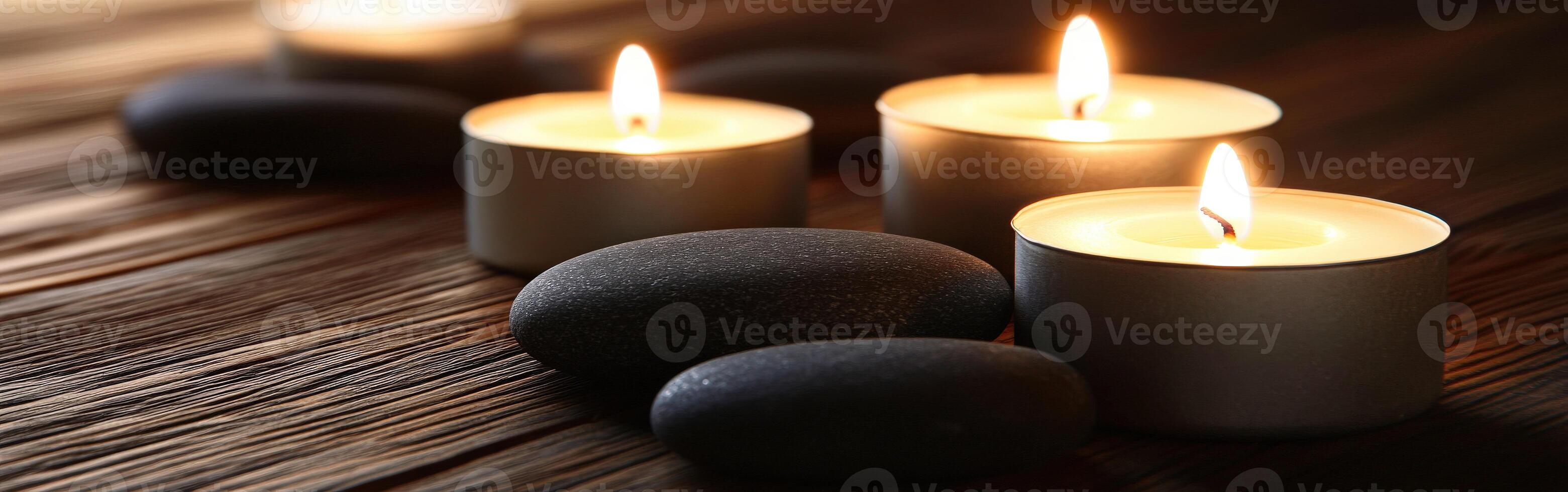 Tranquil zen setting with candles and smooth stones at dusk photo