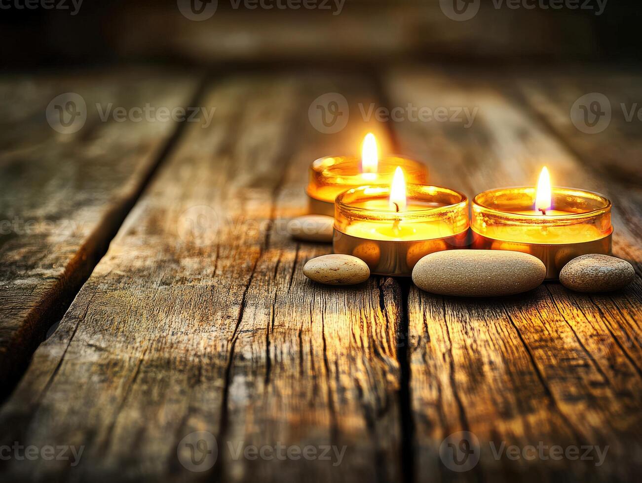Tranquil zen setting with candles and smooth stones on wooden surface photo